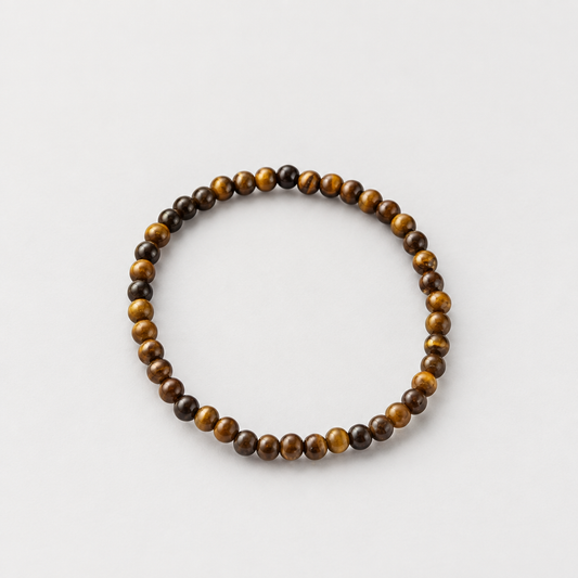 4 mm tiger’s eye bracelet on a light warm-grey background