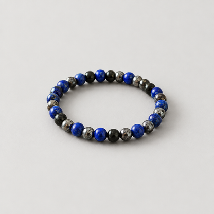 Black-and-blue bracelet on a light warm-grey background