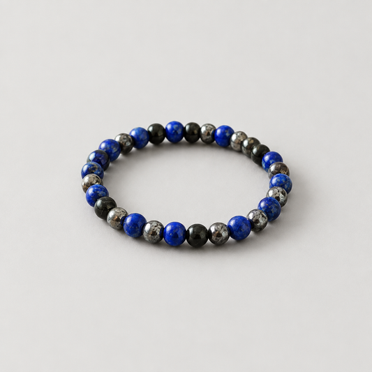 Black-and-blue bracelet on a light warm-grey background