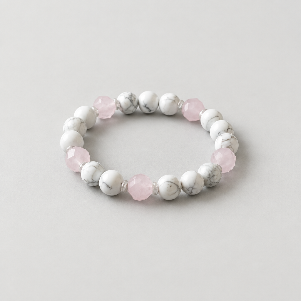 Rose quartz and howlite bracelet on a light warm-grey background